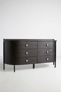 a black dresser sitting on top of a white floor