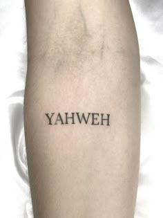 the word yahweh written in black ink on a person's leg