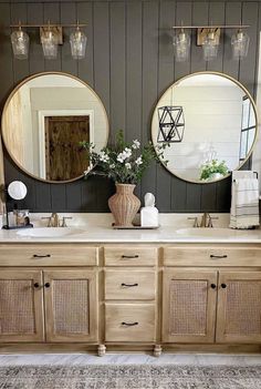 two round mirrors are above the double sinks in this bathroom