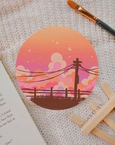 an image of a sunset with power lines in the background and a book next to it