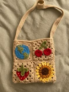 a crocheted purse with fruits and vegetables on it