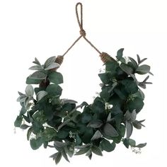 a green wreath hanging from a rope