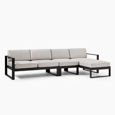 a black and white sectional couch with cushions