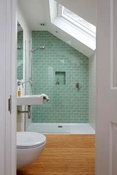 an open door leading to a bathroom with a skylight