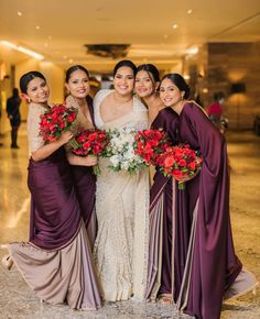 the bride and her bridesmaids pose for a photo