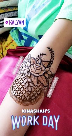 a woman's arm with henna on it and the words work day written in arabic