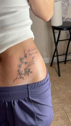 a woman with a tattoo on her stomach