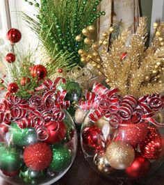 two glass bowls filled with ornaments on top of a table