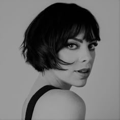 a black and white photo of a woman with short hair