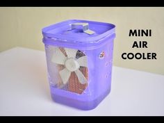 a purple plastic container with a fan on top and the words mini air cooler above it