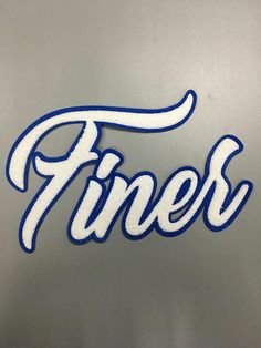 the word finesr is made out of white and blue letters on a metal surface