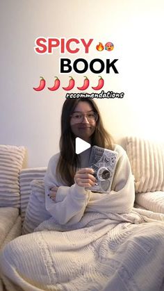 a woman sitting on a couch holding a book in front of her face with the caption spicy book