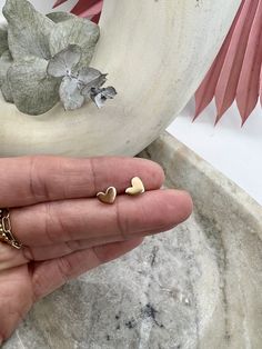 Our charming 14k gold-filled mini heart studs are perfect for daily wear. With their smooth and shiny finish, these charming and timeless earrings are a great fit for both adults and kids. We use 14k gold-filled high quality metal manufactured in the US.  All of the jewelry is handmade in my little California studio. Tarnish Resistant Gold Plated Dainty Heart Earrings, Minimalist Yellow Gold Heart Earrings For Valentine's Day, Gold Minimalist Heart Earrings For Everyday, Hypoallergenic Gold Plated Heart Earrings Gift, Minimalist Gold Heart Earrings With Charm, Gold Double Heart Dainty Earrings, Gold Dainty Heart Earrings Tarnish Resistant, Minimalist Gold Hypoallergenic Heart Earrings, Dainty Gold Plated Heart Earrings