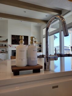 two white bottles sitting on top of a kitchen counter