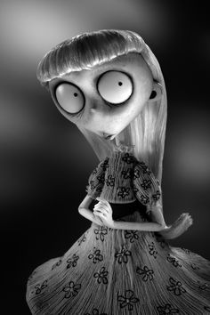 a black and white photo of a cartoon character with big eyes, wearing a dress