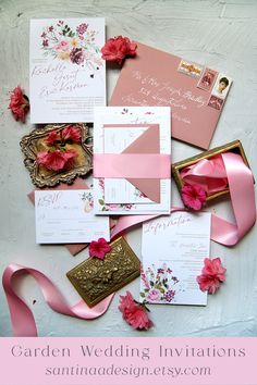 the wedding stationery is laid out on top of each other with pink flowers and ribbons