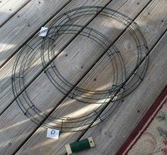 a wire circle sitting on top of a wooden floor