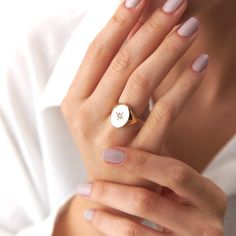 a woman wearing a ring with a star on it