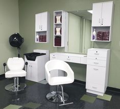 a hair salon with white chairs and green walls