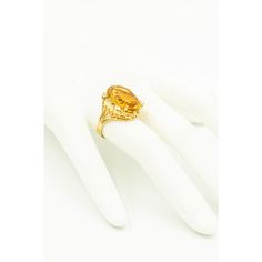 Gorgeous yellow orange color oval faceted citrine accented with 4 prong set approximate size .08 carat diamonds and six 3 prong set approximate .02 carats diamonds. Approximate total weight in diamonds is .44 carats. The sides have open scroll design that resembles a heart.  The citrine measures 13.5mm x 8.5mm.  The ring is 10k yellow gold. US size 8.5.  It can be sized.  The ring measures .76" wide by .86" tall by .36" deep. Yellow Oval Topaz Ring In 14k Gold, Yellow Gold Citrine Oval Diamond Ring, Oval Yellow Sapphire Topaz Ring For Formal Occasions, Oval Citrine Diamond Ring In Yellow Gold, Formal Citrine Birthstone Ring In Fine Jewelry Style, Oval Topaz Birthstone Ring In Yellow Gold, Formal Fine Jewelry Citrine Birthstone Ring, Citrine Birthstone Ring For Formal Occasions, Elegant Yellow Oval Birthstone Ring