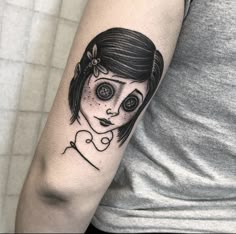 a woman's arm with a black and white tattoo on it