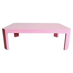 a pink wooden table with two legs