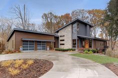 a large house with two garages in front of it