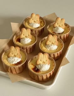 small pies with marshmallow toppings in paper cups on a tray, ready to be eaten