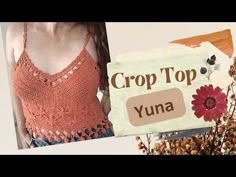 a woman in an orange top standing next to a sign that says crop top yuna