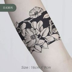 a black and white flower tattoo on the arm