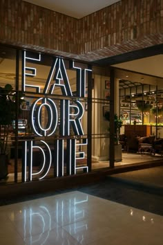 a neon sign that reads eat our die