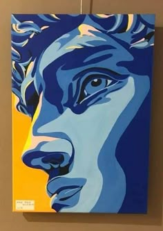 a painting of a man's face on a yellow and blue background is hanging from the wall