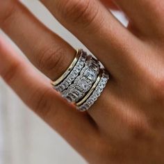 a woman's hand with three different rings on top of her finger and the ring is