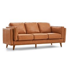 a tan leather couch with wooden legs and arm rests on an isolated white background,