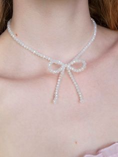 This sparkling, soft white beaded bow necklace is an intricately, handmade piece of jewelry that goes well with everything. They can easily be dressed up or down for casual and formal/going-out looks, making a great everyday necklace that is still eye-catching and unique. A great amount of care, passion, and attention to detail goes into every step of its creation, making it a truly high-quality and special piece of jewelry that you can feel good about wearing for years to come. This makes the perfect gift for her. OTHER COLORS HERE: https://www.etsy.com/shop/OliviaBeeken?section_id=42513357 Details -Made with medical grade stainless steel finishings so it will NEVER tarnish or cause skin irritation.  -Necklace length is 14.5 inches -There is a lobster claw and a 2-inch chain on the end so Adjustable White Bow Jewelry, White Bow Tie Jewelry As Gift, White Bow Tie Jewelry For Gift, White Jewelry With Decorative Bow For Party, White Pearl Jewelry With Ribbon Detail, White Pearl Jewelry With Ribbon, Party Jewelry With Decorative Bow In White, White Butterfly Knot Jewelry For Wedding, White Ribbon Necklace For Parties