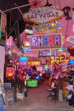 neon signs hang from the ceiling in a las vegas shop