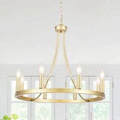 a chandelier hanging from the ceiling in a room with white walls and windows