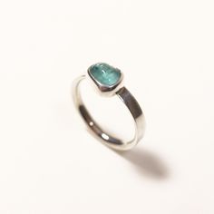 UK Finger Size: L - US Finger Size: 5 1/2 Hallmarks: 925 (Sterling Silver Mark) Weight: 2.4 grams  Gemstones: 1x Apatite 0.65ct - (4.5mm)  This item is part of the Handcrafted By Clark Collection, created by Clark Rennie. Each piece is lovingly handmade using premium materials like precious metals and ethically sourced natural gemstones. Clark's commitment to quality means every piece is designed to be cherished and passed down through generations. Please see the accompanying photos for a detail Modern Sterling Silver Emerald Ring, Turquoise Sapphire Gemstone Ring In Sterling Silver, Turquoise Sapphire Ring In Sterling Silver, Turquoise Sapphire Ring In Sterling Silver As Gift, Turquoise Sapphire Ring With Sterling Silver, Silver Minimalist Emerald Gemstone Ring, Everyday Sterling Silver Emerald Ring, Modern Sterling Silver Emerald Ring With Bezel Setting, Cabochons Stones