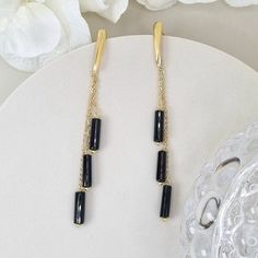 Introducing our stunning black onyx long drop dangle earrings with a fine gold chain. These earrings are the perfect accessory for any stylish woman who wants to make a bold statement. The deep black onyx gemstones add a touch of elegance and sophistication, while the long drop design adds a modern twist. The fine gold chain adds a touch of glamour, creating a beautiful contrast against the black onyx. Whether you're dressing up for a special occasion or adding a touch of sophistication to your Onyx Crystal, Black Onyx Necklace, Long Tassel Earrings, Birthday Gift For Women, Drop Design, Onyx Necklace, Onyx Earrings, Earrings Crystal, Handmade Ideas