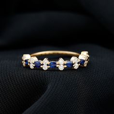 Product Details Surprise the one you love with this beautiful Blue Sapphire and Diamond Ring. Designed with a classic East West style, this half eternity ring features a gorgeous Round Shape blue sapphire as the center gemstone set in a prong setting. Accented with sparkling Diamond stones, this ring is crafted for a stunning and durable piece of jewelry. Show your love and commitment with this gorgeous ring. Product Information SKU SHP-RINGS0821183767 Width 1.8 mm Height 4 mm Weight 1.29 gm (Approximate) BLUE SAPPHIRE INFORMATION No.of Stones 7 Pieces Total Weight 0.21 Carat (Approximate) Dimension(approx) Marquise-1.50X3.00 mm-7 Pcs Color Blue Cut Brilliant Shape Marquise Setting Type Prong-Setting Quality Grade AAA DIAMOND INFORMATION No.of Stones 16 Pieces Total Weight 0.40 Carat (Appr Half Eternity Ring Diamond, Gorgeous Ring, Sapphire And Diamond Ring, Half Eternity Ring, Sparkling Diamond, 18k Yellow Gold Ring, Jewelry Show, Blue Sapphire Rings, East West