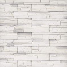 a white brick wall that is made out of stone