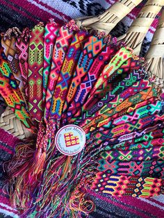 colorful woven items are displayed on the table