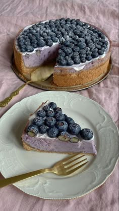 a slice of blueberry cheesecake on a plate with a fork