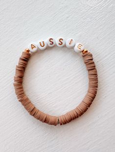 Rock the dog mom look with our Aussie Bracelet! Made from recycled beads, this bracelet adds a fun twist to your wrist game. Measuring 6.5", it's the perfect accessory for any outfit. Don't miss out on this must-have for all dog moms out there! Price is for one bracelet only with the lettering. *Modern Companion does not make this product. It's curated in our retail store. Personalized Adjustable Heishi Beads Bracelet, Personalized Adjustable Heishi Beaded Bracelets, Adjustable Letter Beads Bracelets For Everyday, Adjustable Everyday Bracelets With Letter Beads, Adjustable Heishi Beads Friendship Bracelet, Adjustable Casual Stretch Bracelet For Personalized Gift, Casual Adjustable Stretch Bracelet For Personalized Gift, Custom Name Adjustable Heishi Beads Jewelry, Adjustable Personalized Brown Beaded Bracelets