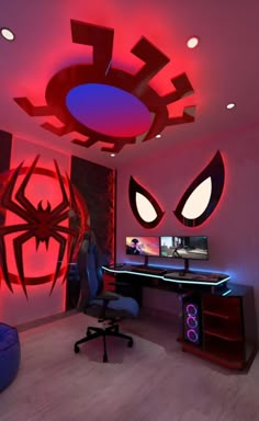 a room with a desk, chair and spiderman wall decals on the walls