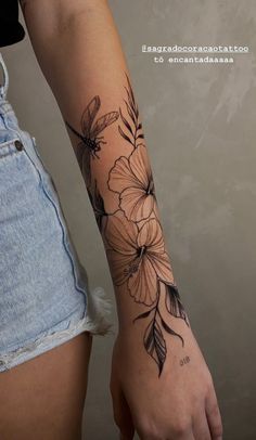 a woman with a flower tattoo on her arm