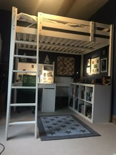 there is a loft bed with a desk underneath it and shelves on the bottom floor