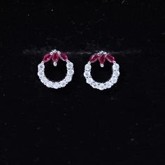 Product Details Elevate your style with these timeless eternity stud earrings. Featuring a continuous loop of round moissanite set in an eternity design, they are adorned with three marquise-cut created rubies for an added touch of glitz and glamour. The minimal prongs securely hold the created ruby and moissanite in place, creating a subtle yet captivating statement piece. Product Information SKU SHP-EARRINGS052310017 Weight 1.84 gm (Approximate) LAB CREATED RUBY INFORMATION No.of Stones 6 Piec Round Cubic Zirconia Gemstone Earrings, Round Gemstone Cluster Earrings For Anniversary, Gemstone Cluster Earrings For Anniversary, Anniversary Halo Earrings, Formal Round Gemstone Hoop Earrings, White Gold Round Gemstone Cluster Earrings, Red Round Cubic Zirconia Earrings, Red Cubic Zirconia Round Earrings, Red Round Halo Design Earrings