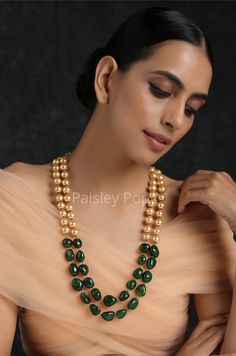 The double-layered pearl necklace is inspired by the rich Indian jewelry-making techniques handcrafted by artisans to celebrate the amalgamation of craftsmanship and modern design. The gold plated stone necklace with jade green stones is a most elegant and perfectly crafted necklace to bejewel your neckline that will create a style statement wherever you go. Pair this gorgeous replica of western jewelry with your ethnic or contemporary ensembles and create a look to remember. Necklace Closure - Green Pearl Chain Necklace For Celebration, Multi-strand Pearl Necklaces With Faceted Beads, Handmade Temple Jewelry Pearl Necklace With Round Beads, Temple Jewelry Necklace With Pearl Drop And Round Beads, Temple Style Pearl Beaded Necklace For Gifts, Celebration Pearl Chain Necklace With Round Beads, Handmade Pearl Necklaces For Festive Occasions, Elegant Pearl Necklace With Faceted Oval Beads, Double Strand Pearl Necklaces With Gemstone Beads