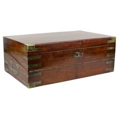 an old wooden box with brass trimmings on the top and bottom, sitting against a white background